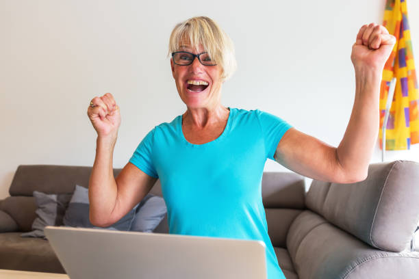istock cheering woman sitting at a laptop 843438176