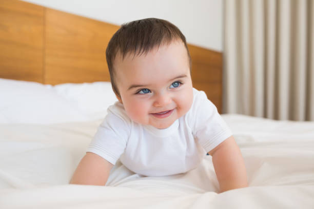 istock Happy baby boy in bed 843441340