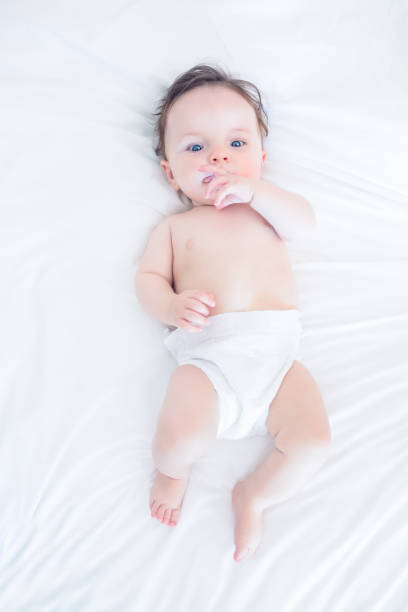 istock Innocent baby with finger in mouth 843441772