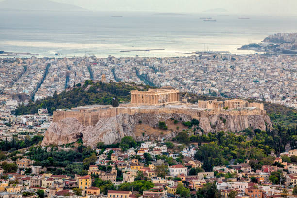 Athens Cityscape Acropolis Greece Aerial view over the city of Athens towards the mediterranean sea with the famous ancient greek Athens Acropolis in the center. Athens, Greece. parthenon athens photos stock pictures, royalty-free photos & images
