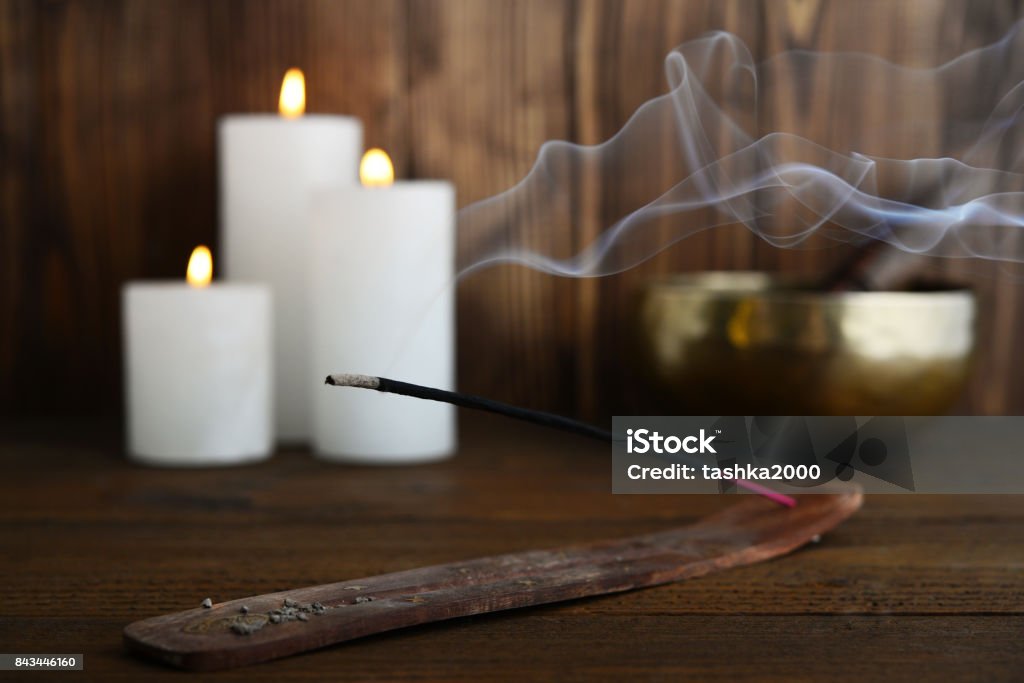 Indian incense stick Indian incense stick with smoke on wooden background closeup Incense Stock Photo