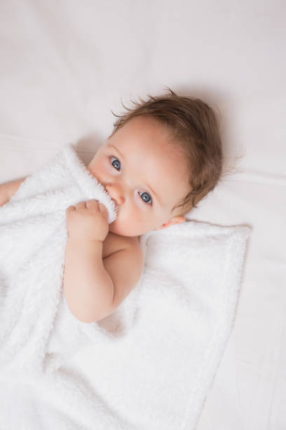 istock Cute baby holding blanket in crib 843452980