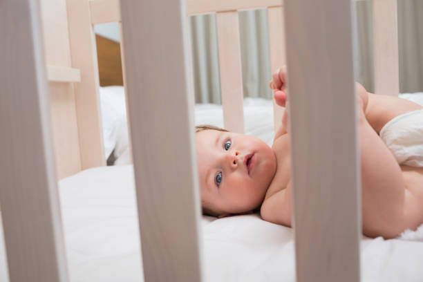 istock Innocent baby boy lying in crib 843455070