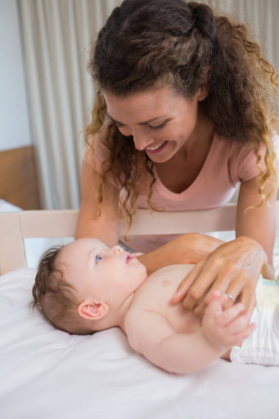 istock Mother looking at baby lying in crib 843455328