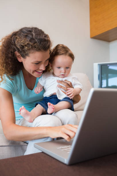 istock Mother showing laptop to baby 843455734