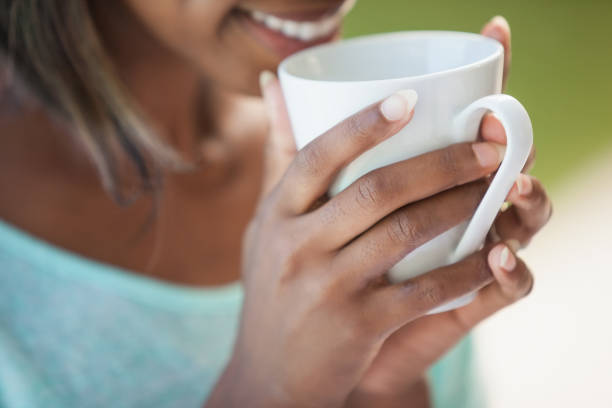 istock Smiling woman having coffee outside 843459548