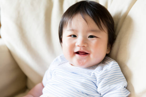 istock asian baby smiling on sofa 843463224