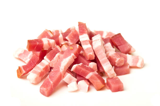 Bacon cubes on white background stock photo