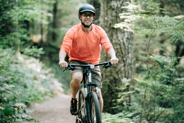 istock Mature Man Mountain Biking in Forest 843466594