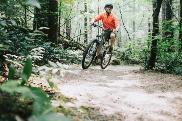 istock Mature Man Mountain Biking in Forest 843466700