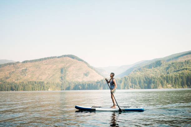 istock Mature Woman Paddleboarding 843468900
