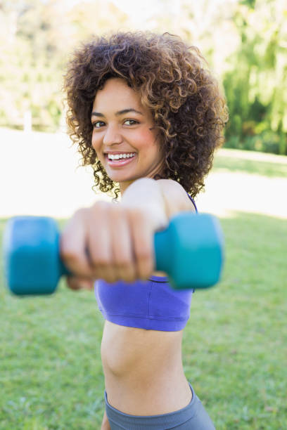 istock Smiling woman lifting hands weights 843469122