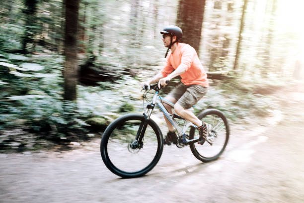 istock Mature Man Mountain Biking in Forest 843470598