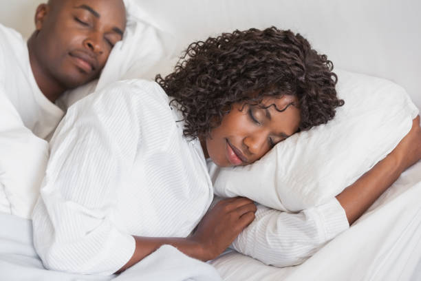 istock Happy couple sleeping together in bed 843473716