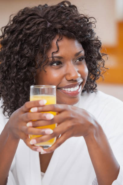 istock Pretty woman in bathrobe having juice 843473888