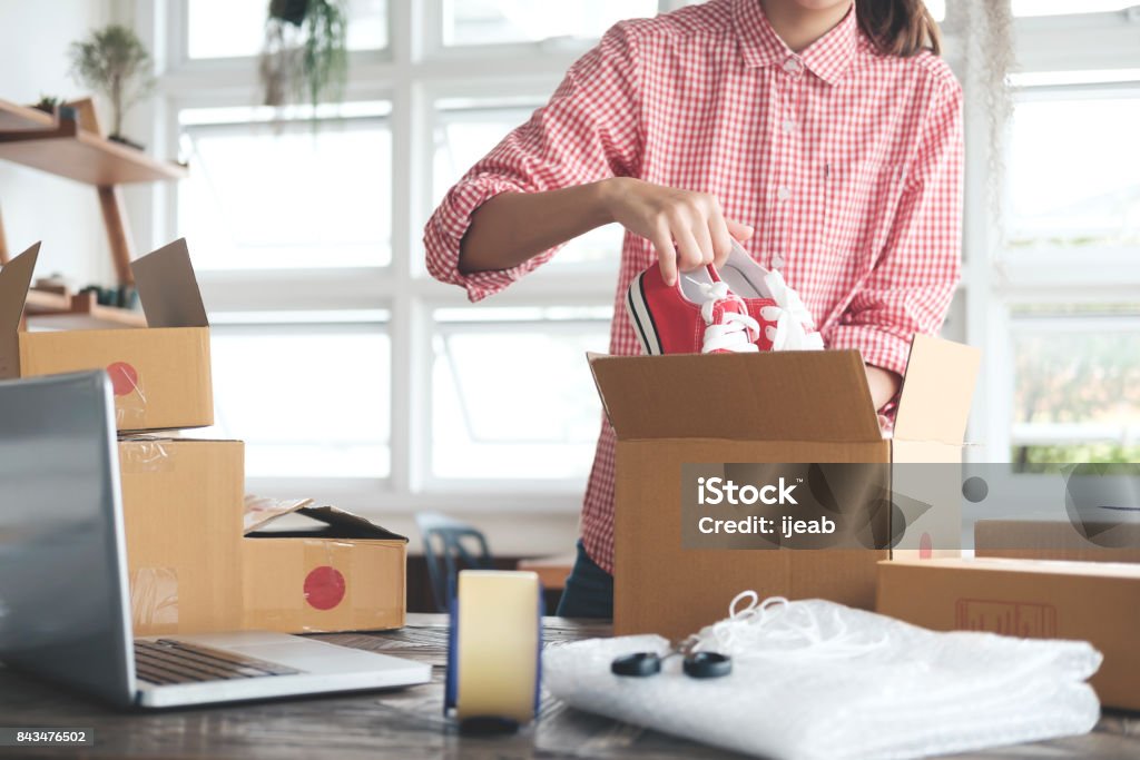 Young startup entrepreneur small business owner working at home, packaging and delivery situation. Business Start up SME concept. Young startup entrepreneur small business owner working at home, packaging and delivery situation. Internet Stock Photo