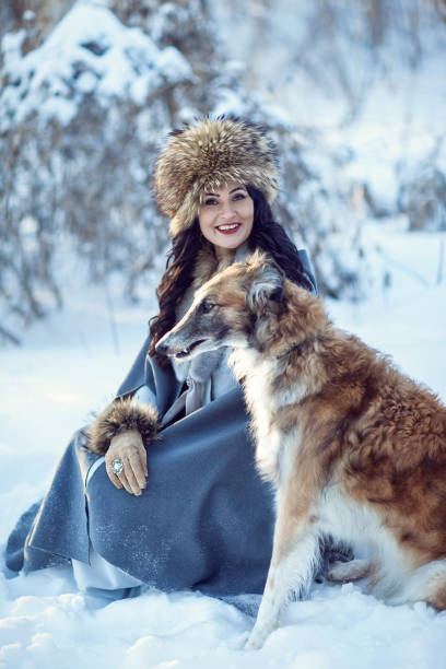 istock A girl with greyhounds on the snow 843476674