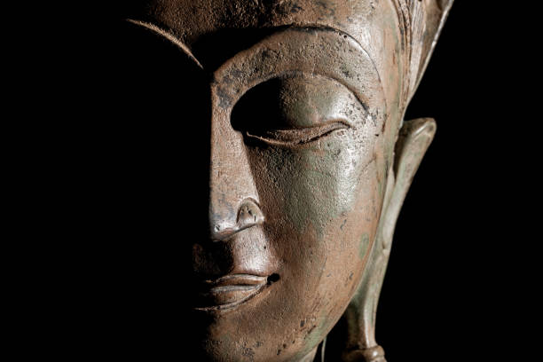 istock Buddha head. Modern buddhism in focus. Bronze statue face in close up. 843477176
