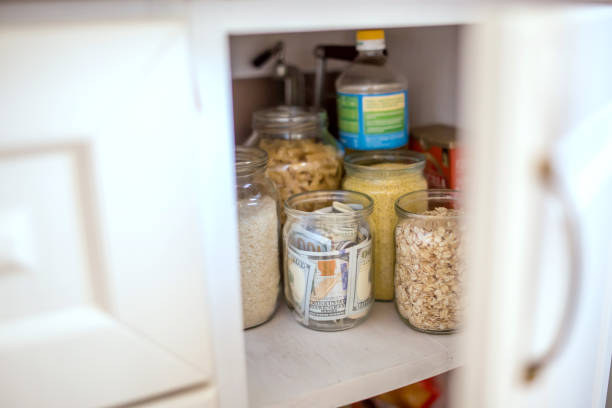 istock Hidden glass jars with dollars between another jars 843478328
