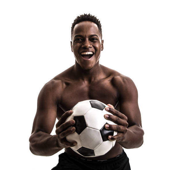istock Afro young man celebrating with soccer ball 843478446