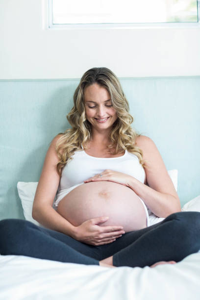 istock Pregnant woman touching her belly 843484102