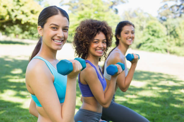 istock Friends lifting dumbbells in park 843484156