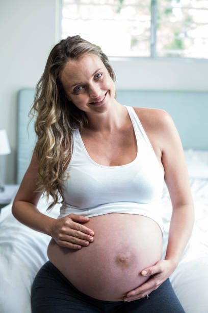 istock Pregnant woman massaging her belly 843484196