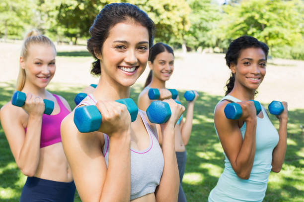 istock Happy multiethnic women lifting dumbbells 843484422