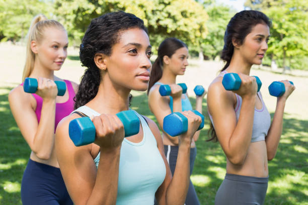 istock Multiethnic women lifting dumbbells 843484428