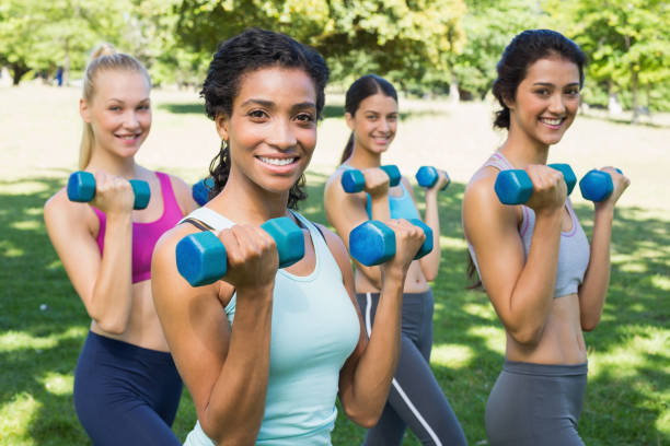 istock Confident sporty women lifting hands weights 843484436