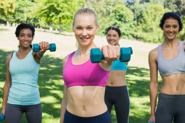 istock Women lifting weights in park 843484464