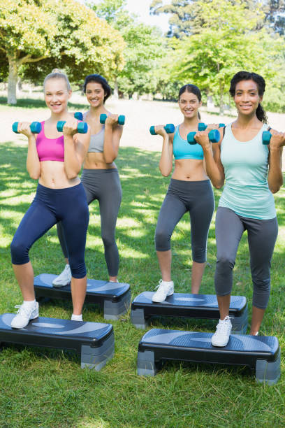 istock Sporty women doing step aerobics in park 843484494