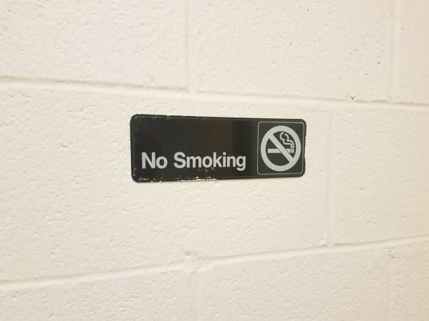 istock no smoking sign on white cement wall 843485128