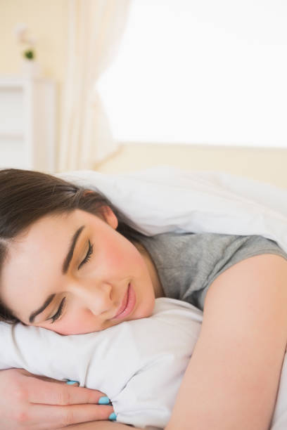 istock Smiling girl sleeping in her bed 843491394