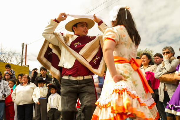 Celebrations of Chile's Independence Day Panguipulli, Chile - September 17, 2014: "Cueca" Chilean typical dance performed by a couple in a National day on Chile. Background people watching. chilean ethnicity stock pictures, royalty-free photos & images