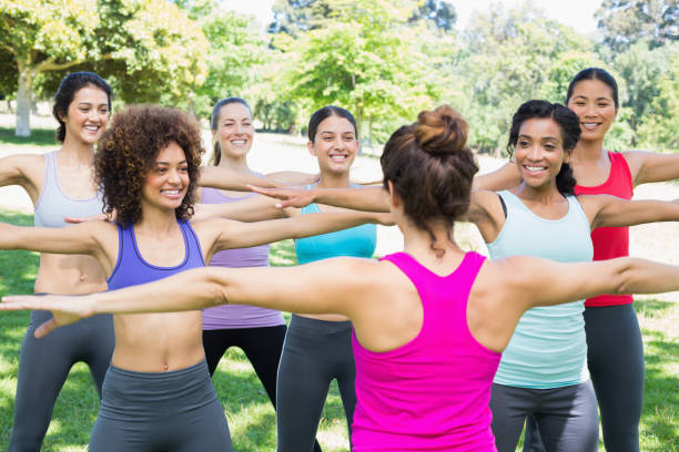 istock Women exercising with instructor at park 843498978