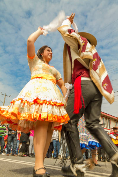 Celebrations of Chile's Independence Day Panguipulli, Chile - September 17, 2014: "Cueca" Chilean typical dance performed by a couple in a National day on Chile at the principal street of the town. Background people watching. chilean ethnicity stock pictures, royalty-free photos & images