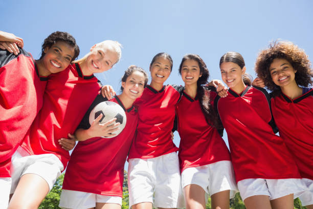 istock Female soccer team against clear blue sky 843499394