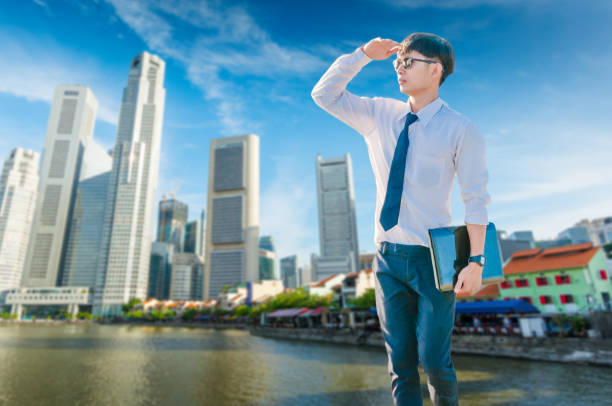 istock Asian business man using laptop and digital tablet in Singapore 843503016
