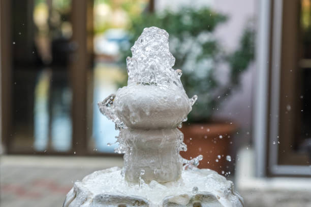 istock Close up water drops flowing from fountain 843503188