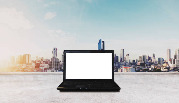 istock Computer laptop on white table, with Bangkok city view in sunrise background. Clipping path computer screen 843509302