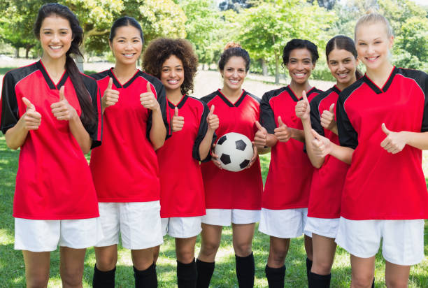 istock Female soccer team gesturing thumbs up at park 843513844