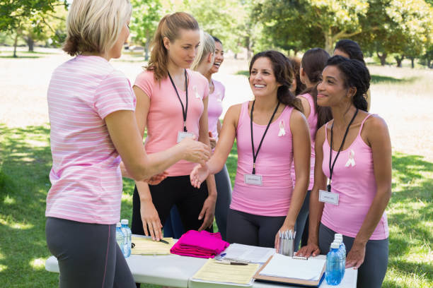 istock Volunteer greeting participants during breast cancer awareness 843514344