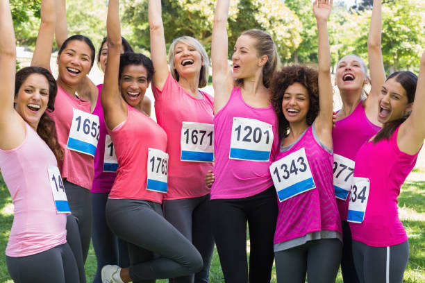 istock Female breast cancer marathon runners cheering 843514474