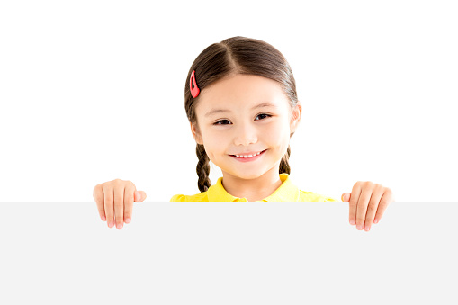 smiling Little girl holding blank white board