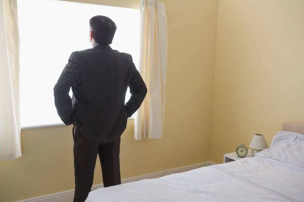 istock Man standing in front of the window 843517982
