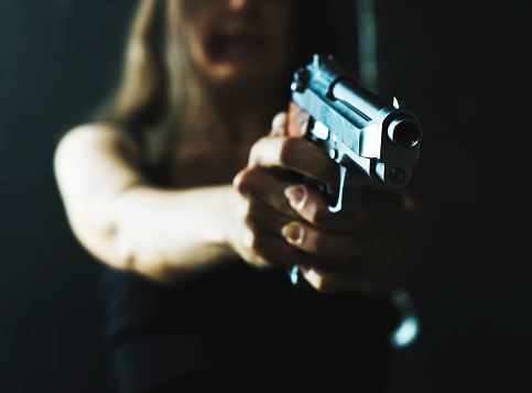 Woman shooting weapon