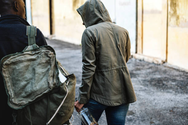 istock Homeless people walking and holding alcohol bottle 843526054