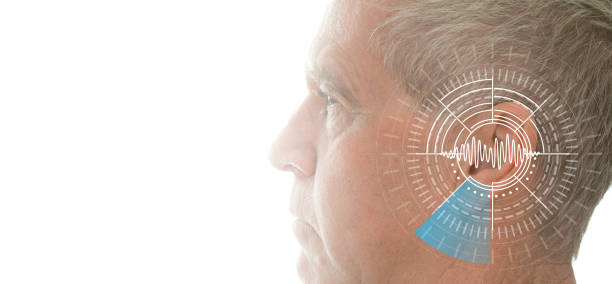 Hearing test showing ear of senior man with sound waves simulation technology stock photo