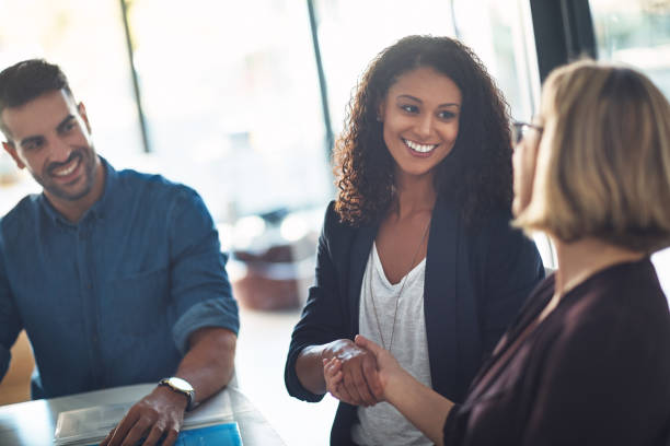 Happy to have you on the team Shot of two businesswomen shaking hands during a meeting in a modern office employee introduction stock pictures, royalty-free photos & images